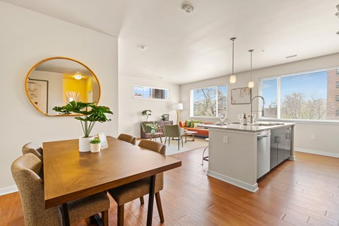 a living room and dining room with a table and a kitchen